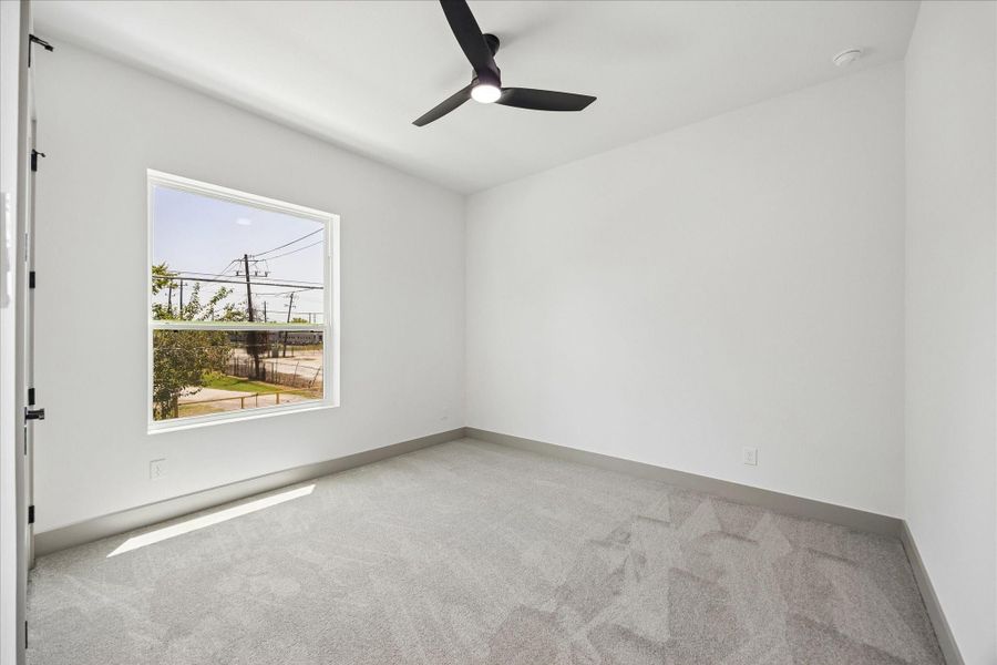Comfortable secondary bedroom with plush carpet, oversized windows, and flexibility for guests, family, or a home office. Comfortable secondary bedroom with plush carpet, oversized windows, and flexibility for guests, family, or a home office.