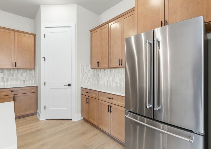 The kitchen has a double door refridgerator with a freezer drawer.