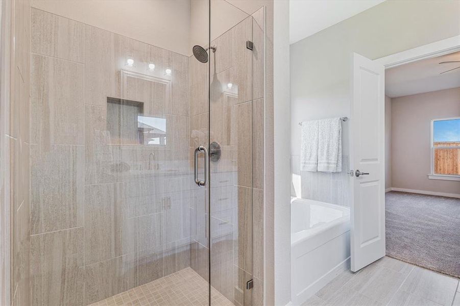 Bathroom with plus walk in shower, tile patterned flooring, and ceiling fan Bathroom with plus walk in shower, tile patterned flooring, and ceiling fan