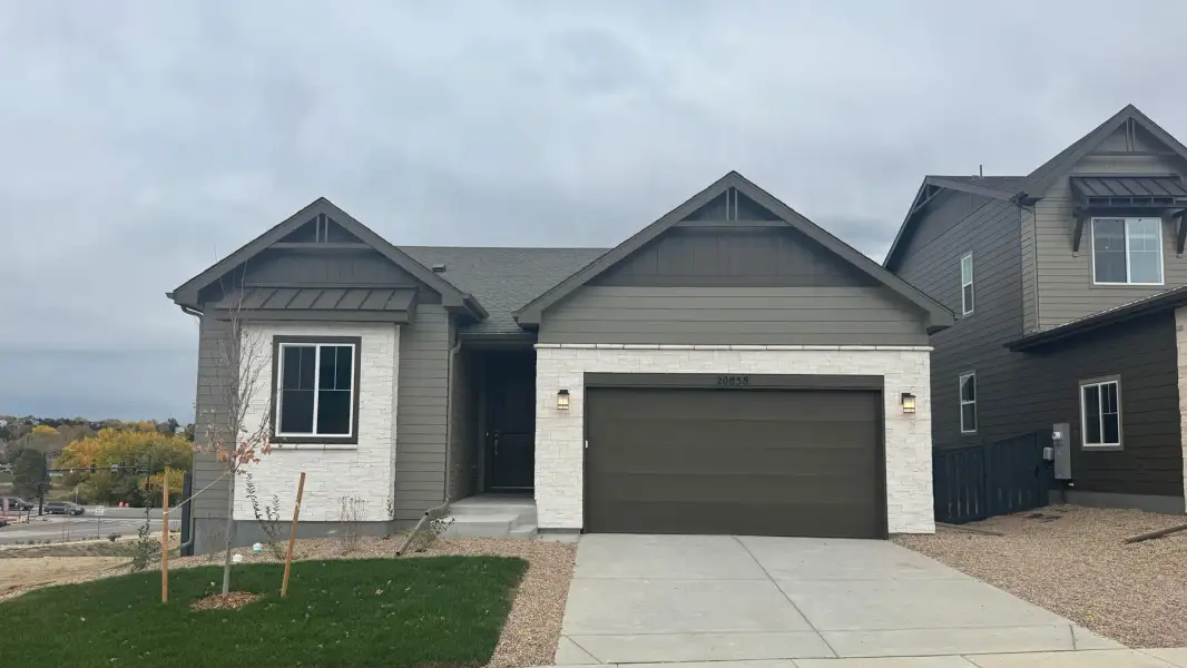 Front exterior of a new home in Legacy at Kime Ranch, Parker, CO, highlighting curb appeal (Image 1). Front exterior of a new home in Legacy at Kime Ranch, Parker, CO, highlighting curb appeal (Image 1).