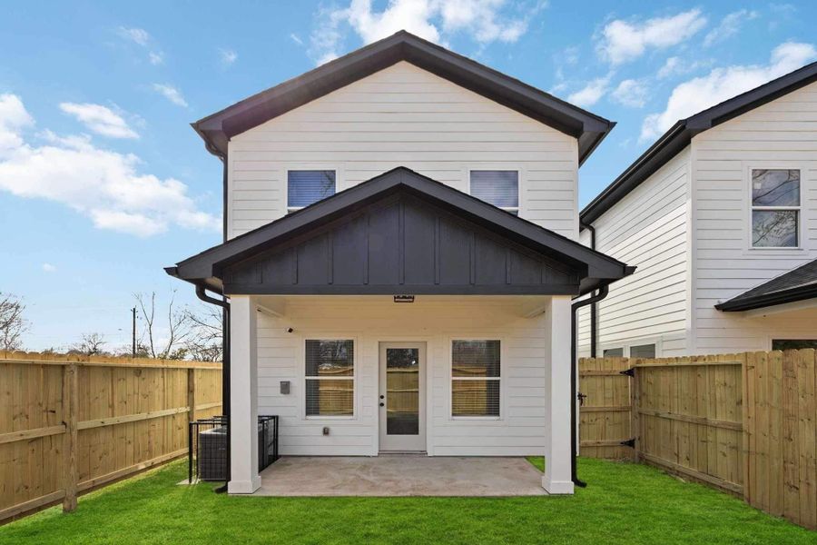 Covered patio overlooking the private backyard, ideal for outdoor dining, relaxing, or entertaining.