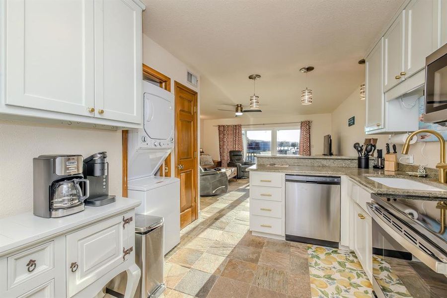 Storage, easy function kitchen space, and a larger size stacked washer-dryer unit make it easy to spend long stays at the condo, or it could easily serve as a primary residence.