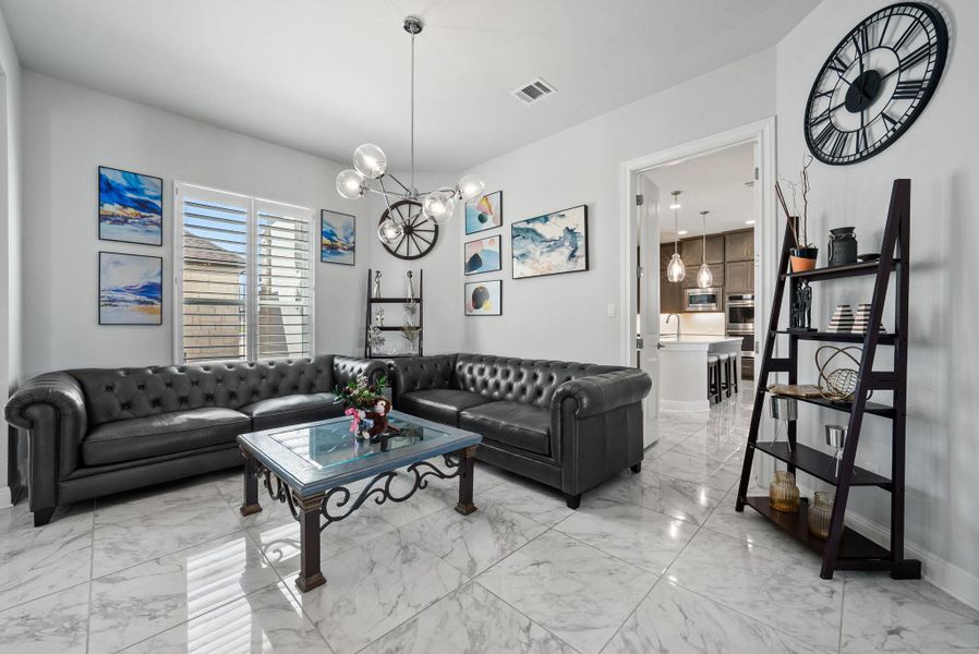 Living area featuring hanging lights and light marble finish flooring