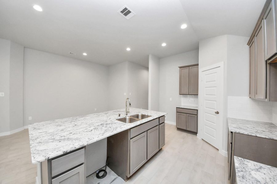 This generously spacious kitchen is a dream realized! Sample photo of completed home with similar floor plan. Actual colors and selections may vary.