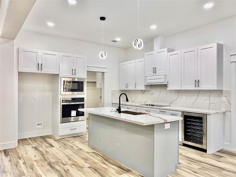 Kitchen Shows off Modern Style LED Light Fixtures as well as LED Can Lighting making the kitchen Super-Bright, and Continues with Gorgeous all Quartz's Back-Splash.