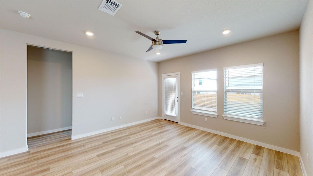 Empty room with light wood-style floors, ceiling fan, and recessed lighting