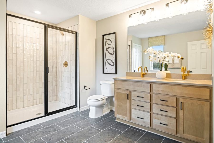 Walk-in shower with tile surround at primary bath Walk-in shower with tile surround at primary bath