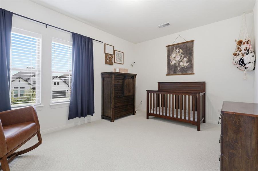 Spacious interior room featuring light-colored carpeting and bright white walls Spacious interior room featuring light-colored carpeting and bright white walls