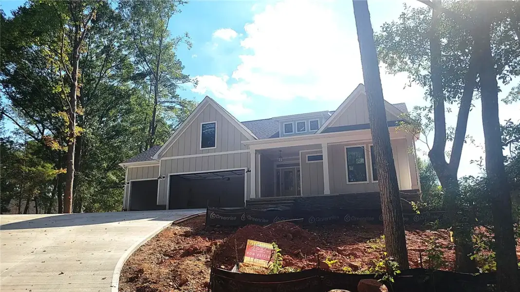 A newly poured concrete driveway leads toward this