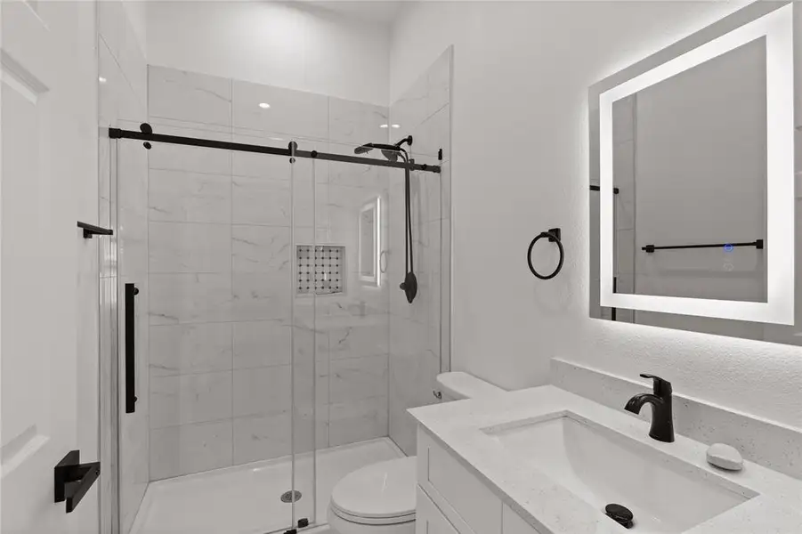 Full bath with vanity and a stall shower