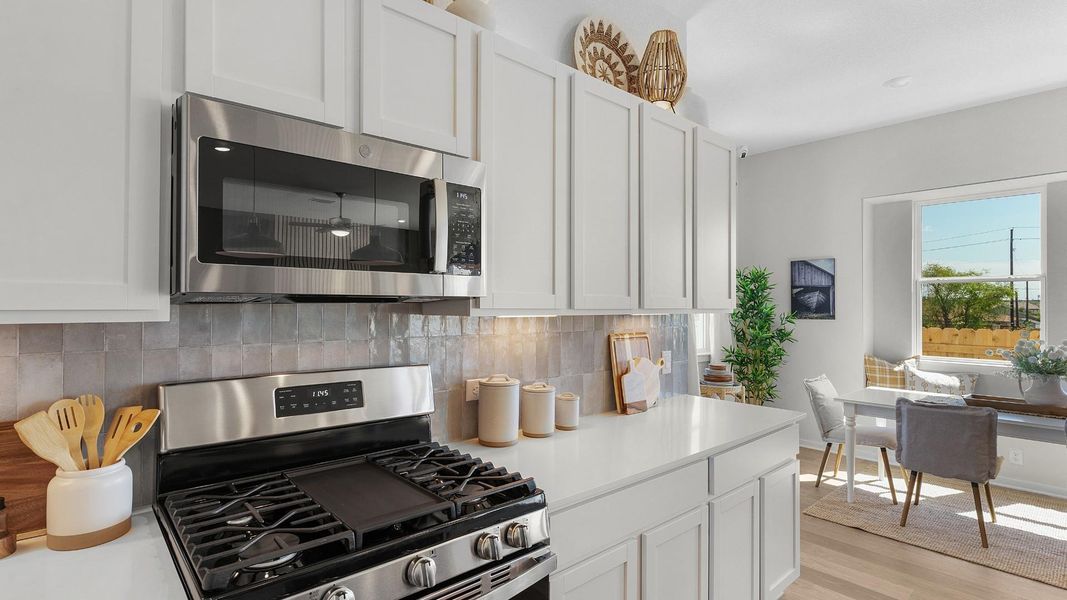 Culinary delights await in this bright kitchen with modern appliances and abundant storage. Culinary delights await in this bright kitchen with modern appliances and abundant storage.