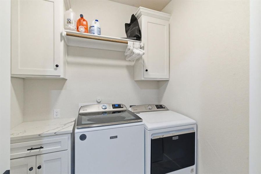 Laundry room featuring cabinet space and separate washer and dryer