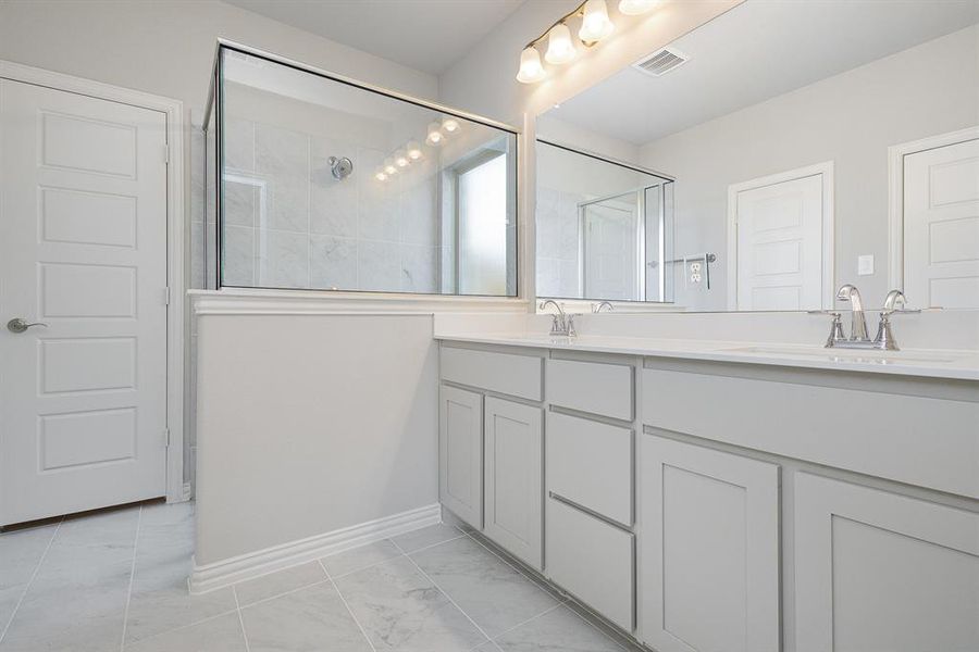 Bathroom featuring vanity and an enclosed shower