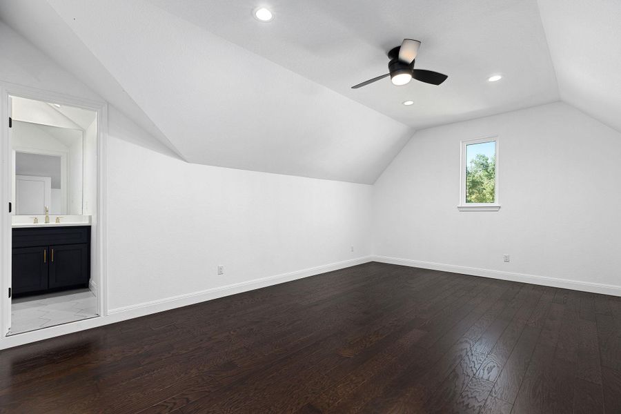 Additional living space with vaulted ceiling, dark wood-style floors, recessed lighting, and ceiling fan Additional living space with vaulted ceiling, dark wood-style floors, recessed lighting, and ceiling fan