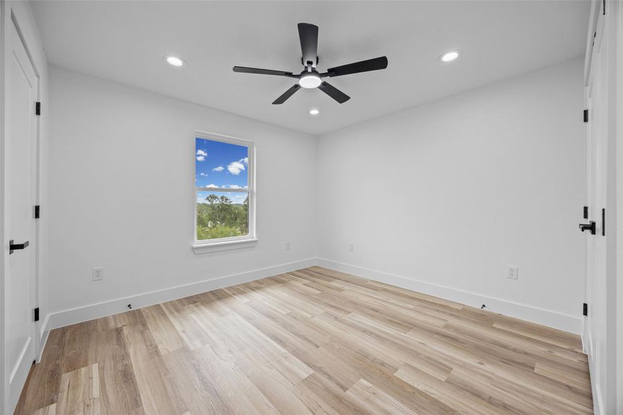 Light wood-finish flooring with white baseboards and walls Light wood-finish flooring with white baseboards and walls