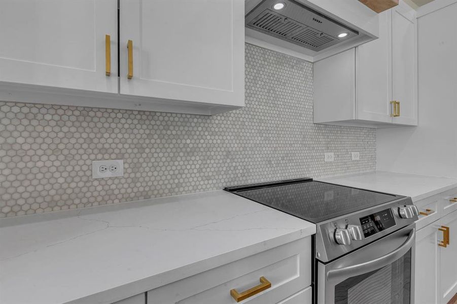 Kitchen featuring extractor fan, tasteful backsplash, stainless steel electric range, light stone countertops, and white cabinets