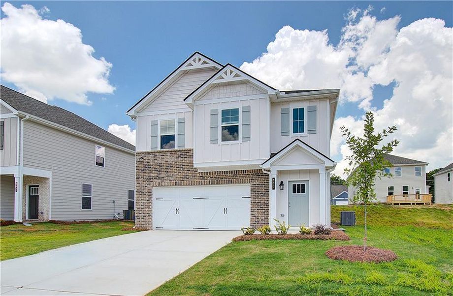 Front exterior of a new home in Enclave at Evergreen, Fairburn, GA, highlighting curb appeal (Image 2). Front exterior of a new home in Enclave at Evergreen, Fairburn, GA, highlighting curb appeal (Image 2).