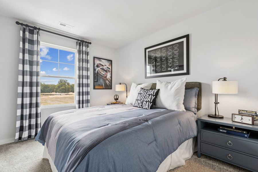 A bedroom with a large window. A bedroom with a large window.