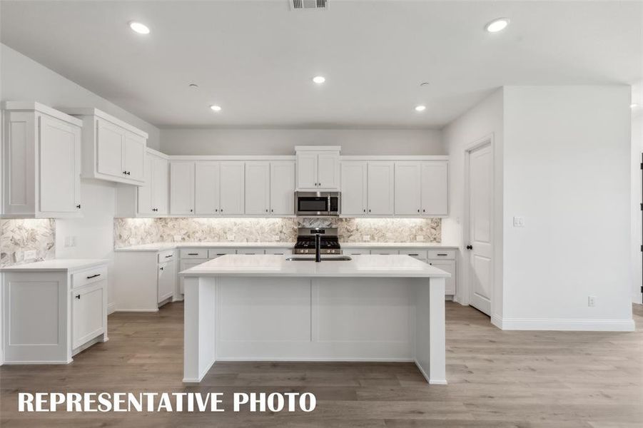 The oversized kitchen island is the perfect place for friends and family to gather round.  REPRESENTATIVE PHOTO