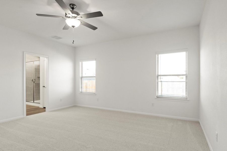 Empty room featuring light carpet and a ceiling fan