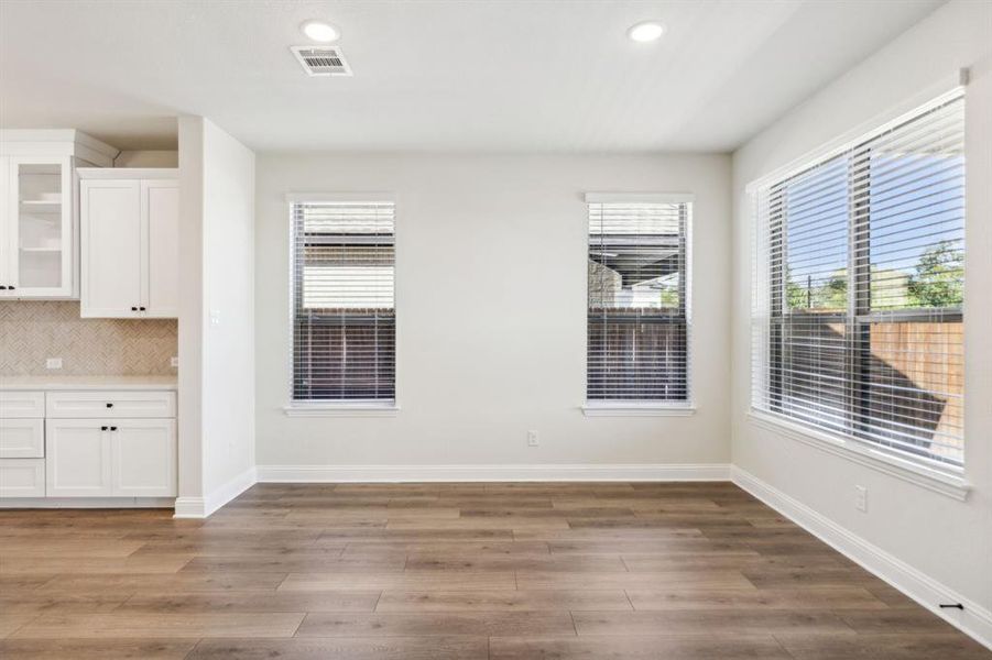 Unfurnished dining area featuring dark hardwood / wood-style floors