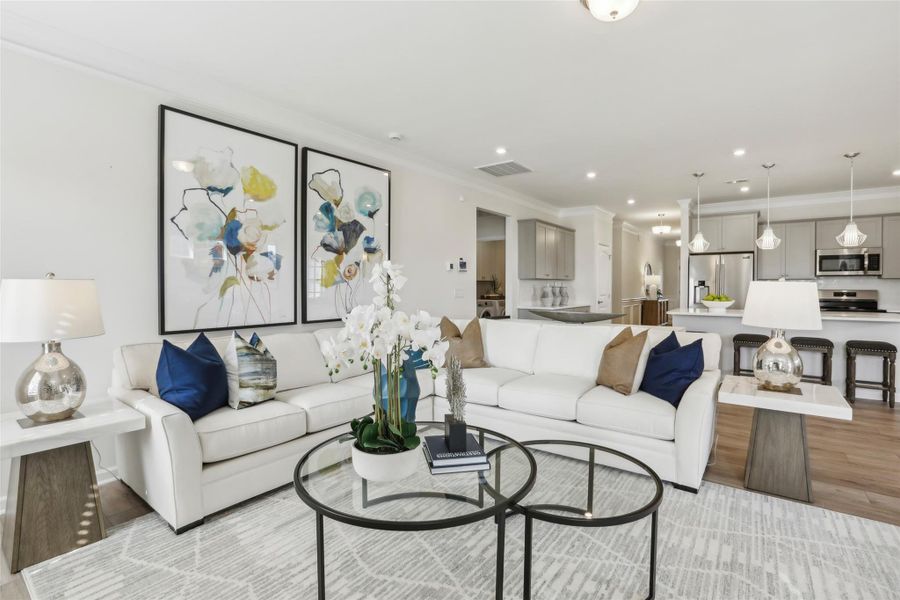 The Avondale-Family Room into Kitchen. Sample floor plan photo used for illustrative purposes only. Upgrades, selections options, windows and colors may vary.