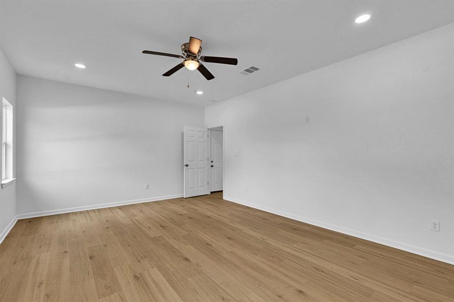 Spare room with light wood finished floors, recessed lighting, and a ceiling fan Spare room with light wood finished floors, recessed lighting, and a ceiling fan