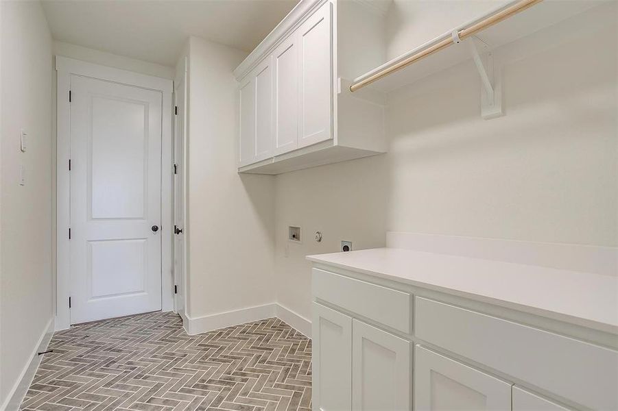 Washroom featuring washer hookup, cabinets, and electric dryer hookup