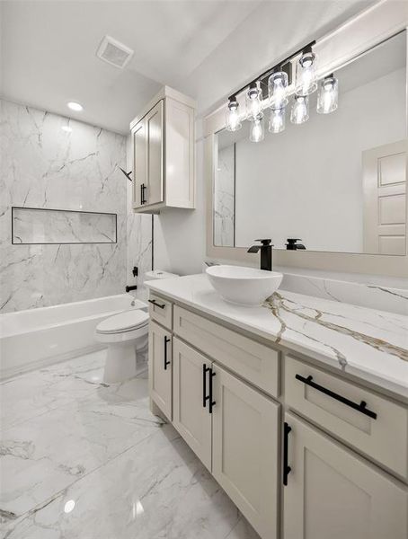 Full bathroom featuring vanity, light marble finish flooring, a combined bath / shower with marble appearance, and recessed lighting