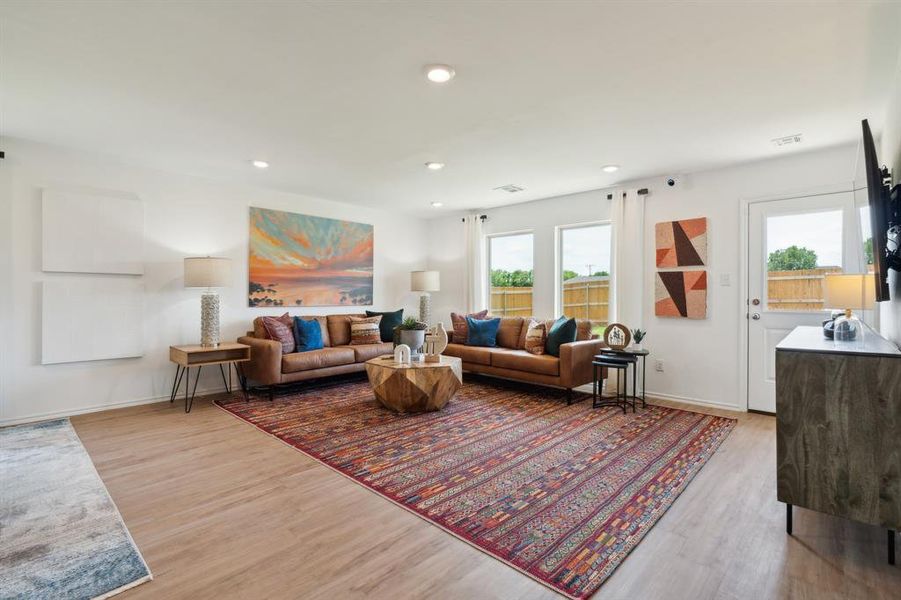 Living room featuring a wealth of natural light and light hardwood / wood-style flooring