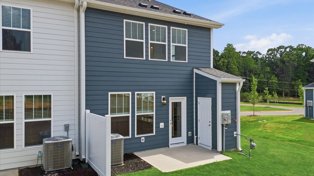 Accomplished rear exterior with a spacious patio that blends comfort and style at Barton Hollow