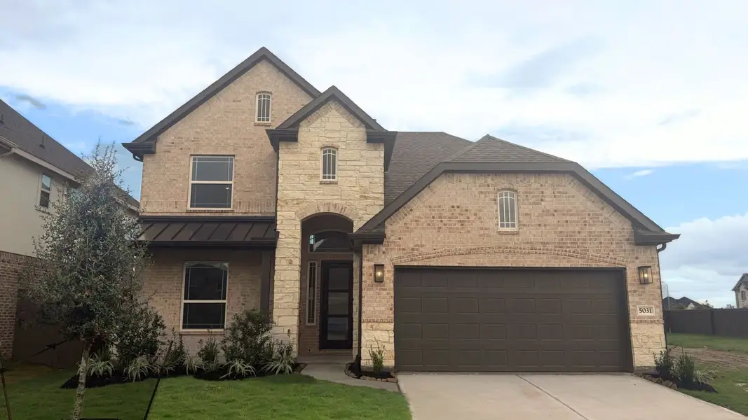 Front exterior of a new home in Brookewater, Rosenberg, TX, highlighting curb appeal (Image 2). Front exterior of a new home in Brookewater, Rosenberg, TX, highlighting curb appeal (Image 2).