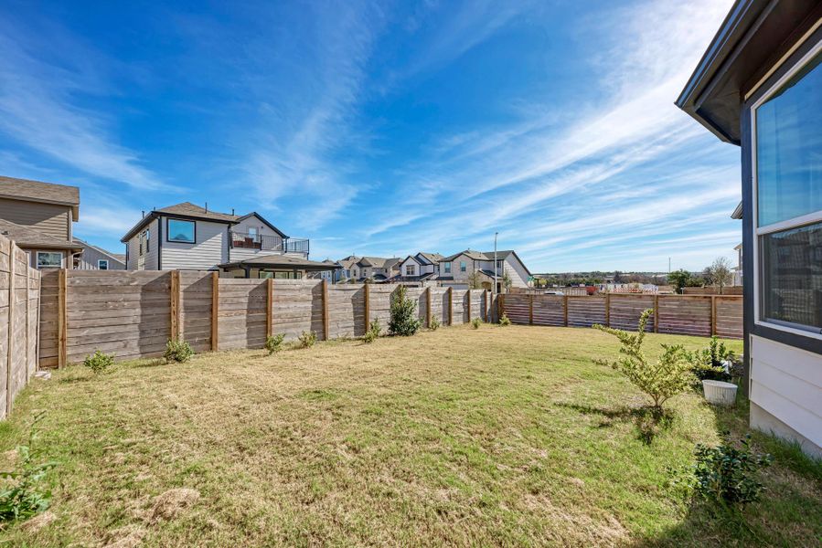 Fenced backyard with a residential view