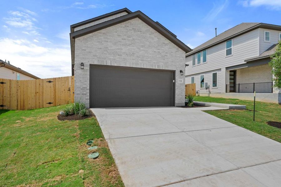 Front exterior of a new home in Terrace Collection At Turner's Crossing, Buda, TX, highlighting curb appeal (Image 23). Front exterior of a new home in Terrace Collection At Turner's Crossing, Buda, TX, highlighting curb appeal (Image 23).
