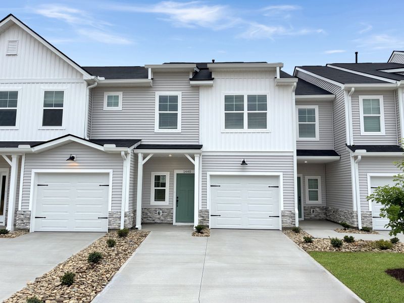 Front exterior of a new home in Reidville Town Center, Reidville, SC, highlighting curb appeal (Image 1). Front exterior of a new home in Reidville Town Center, Reidville, SC, highlighting curb appeal (Image 1).
