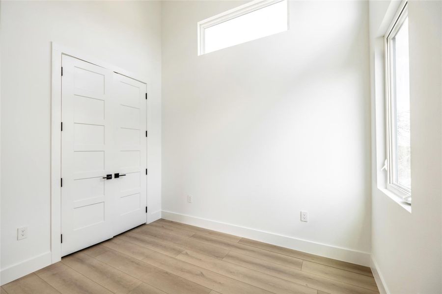 Entryway with baseboards and light wood-type flooring