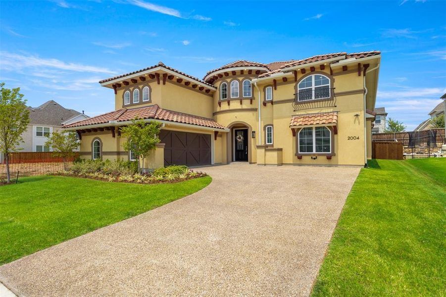 Mediterranean / spanish home featuring driveway, stucco siding, a J-swing driveway, and tiled roof Mediterranean / spanish home featuring driveway, stucco siding, a J-swing driveway, and tiled roof