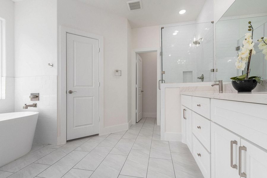 This modern bathroom features a sleek design with a spacious glass shower, a freestanding bathtub, and a double vanity with ample storage. The light color palette and large mirror enhance the bright, airy feel. This modern bathroom features a sleek design with a spacious glass shower, a freestanding bathtub, and a double vanity with ample storage. The light color palette and large mirror enhance the bright, airy feel.