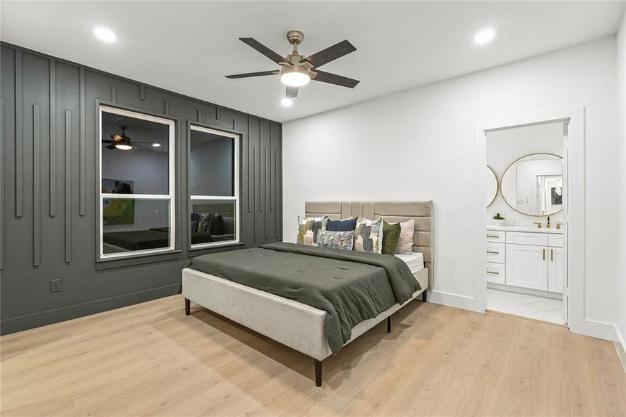 Bedroom featuring light wood-style flooring, recessed lighting, ceiling fan, and ensuite bath