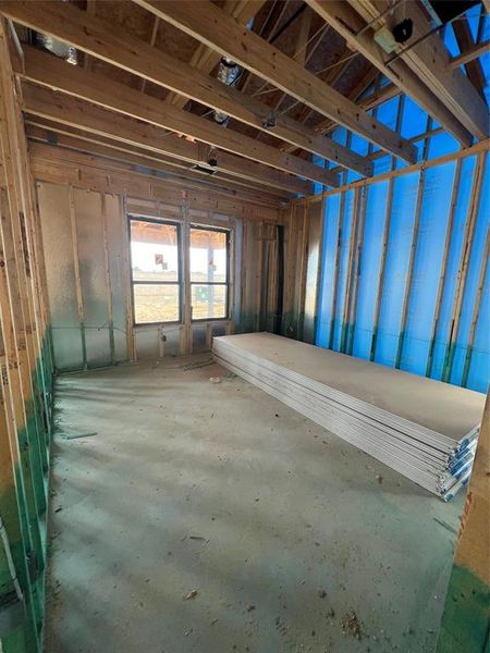 Main bedroom privately located off the back of the house with views of the covered patio. Swipe over to see a representation of this space once completed.