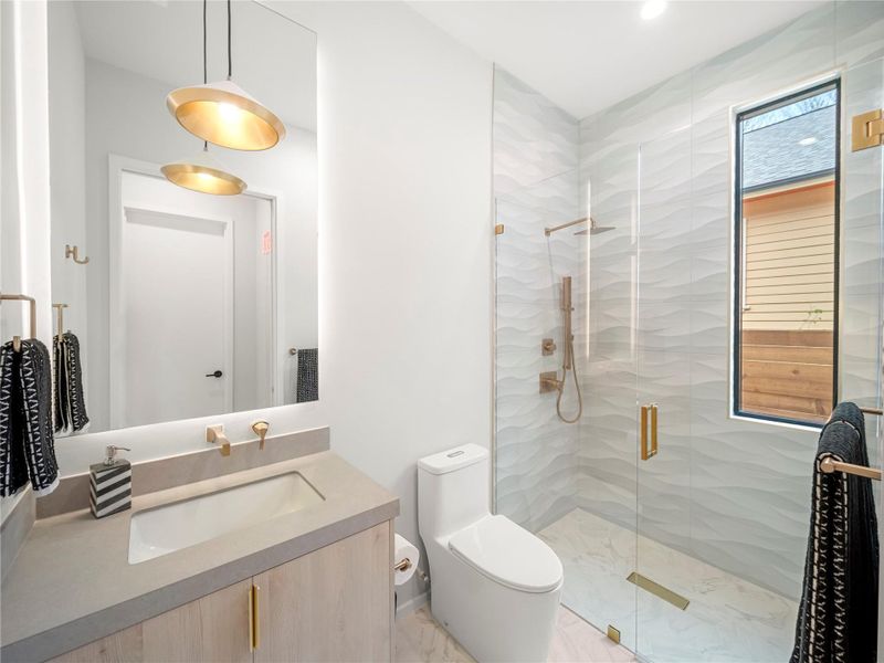 Bathroom featuring vanity and a shower stall