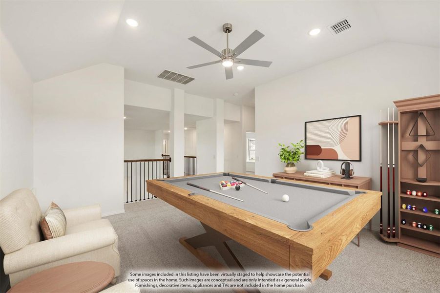 Game room with wood pool table, cue rack, ceiling fan, and open staircase railing on carpet flooring Game room with wood pool table, cue rack, ceiling fan, and open staircase railing on carpet flooring