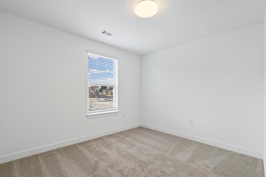 Room featuring neutral carpeting, white walls, and a window with blinds