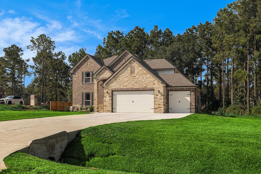 Front exterior of a new home in Deer Pines, Conroe, TX, highlighting curb appeal (Image 18).