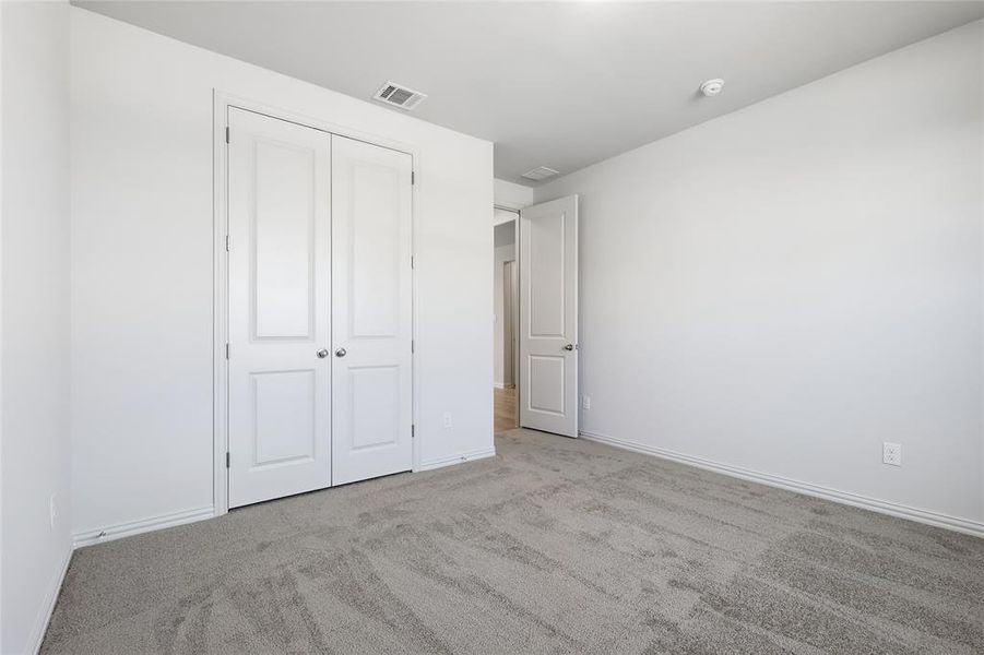Unfurnished bedroom with carpet floors and a closet