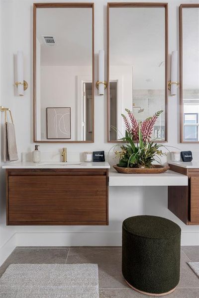 Dual vanity with integrated sinks, quartz countertops, and wood-finish cabinetry