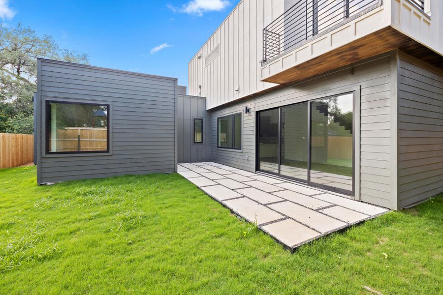Large sliding doors lead out to open patio space