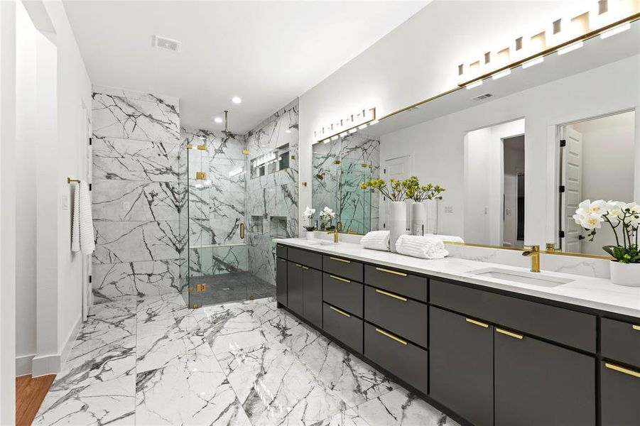 Full bath with double vanity, a marble finish shower, marble finish floor, a sink, and recessed lighting