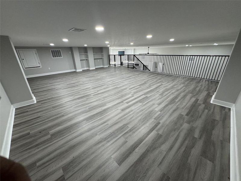 Upstairs Family room / Flex SpaceAI Generated flooring, vinyl plank in process of being installed.