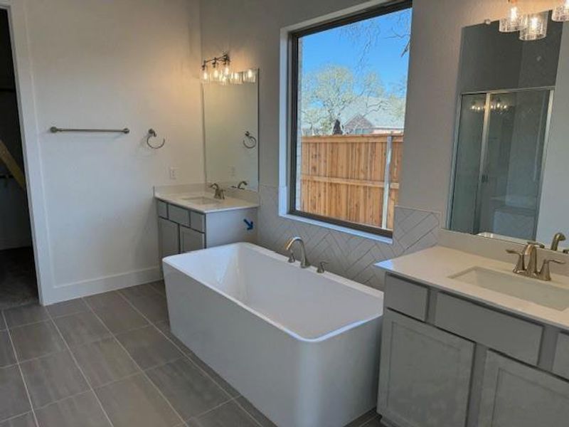 Primary Bedroom with tray ceiling, ceiling fan & bay windows Primary Bedroom with tray ceiling, ceiling fan & bay windows